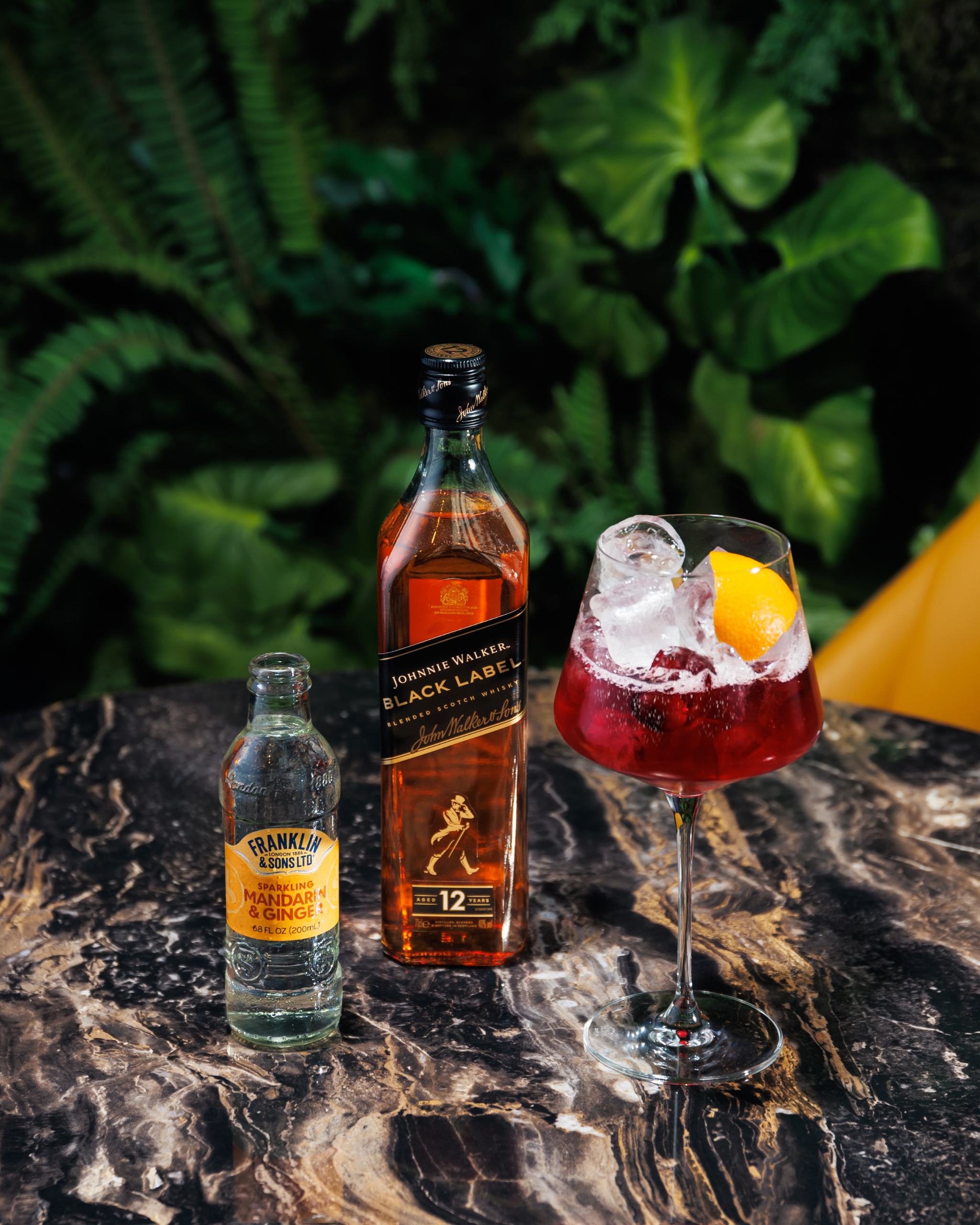 Sparkling mandarin and ginger soda next to a spritz cocktail and Johnnie Walker Black Label whisky | Franklin & Sons
