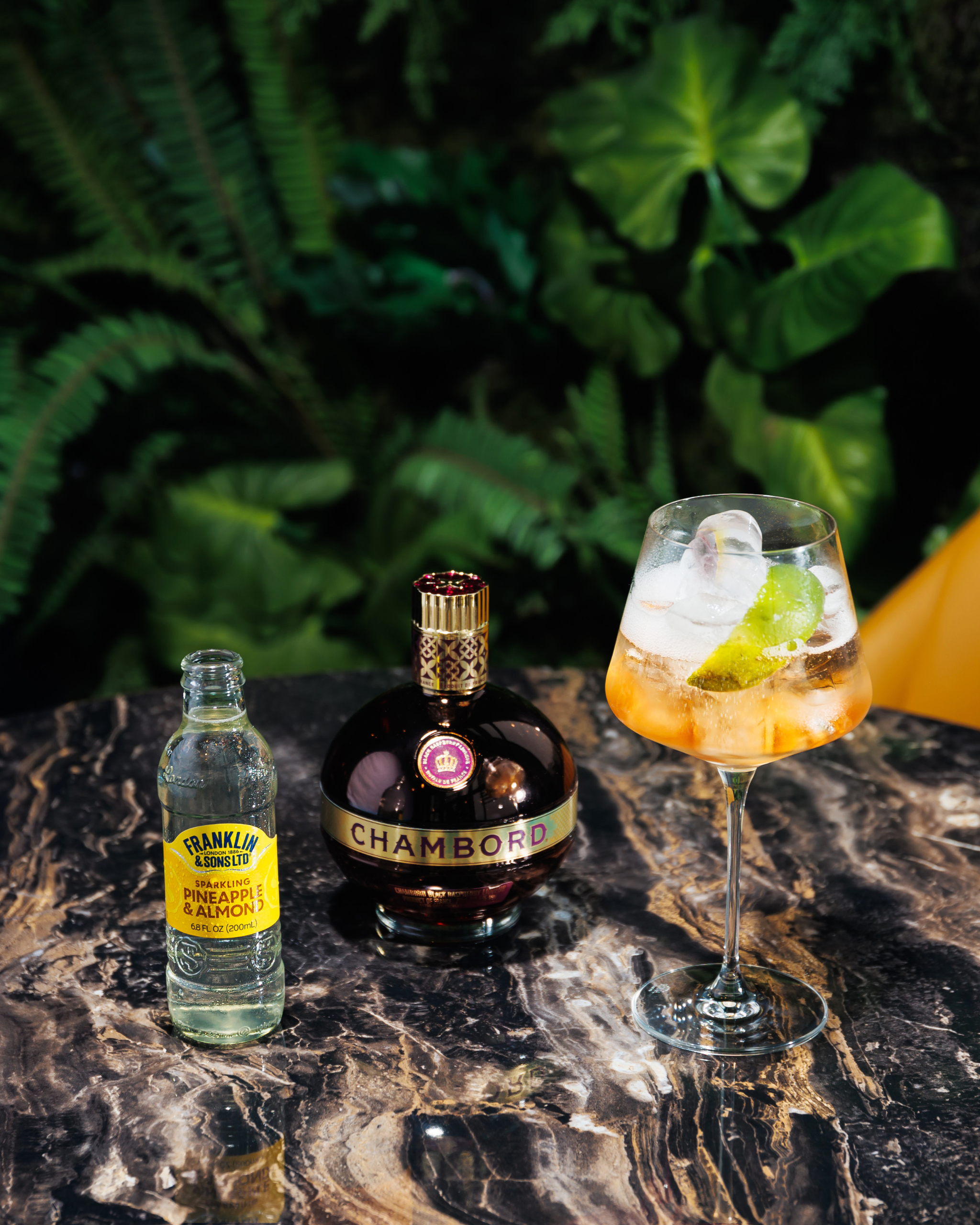 Sparkling Pineapple and almond next to a spritz cocktail garnished with lime peel | Franklin & Sons